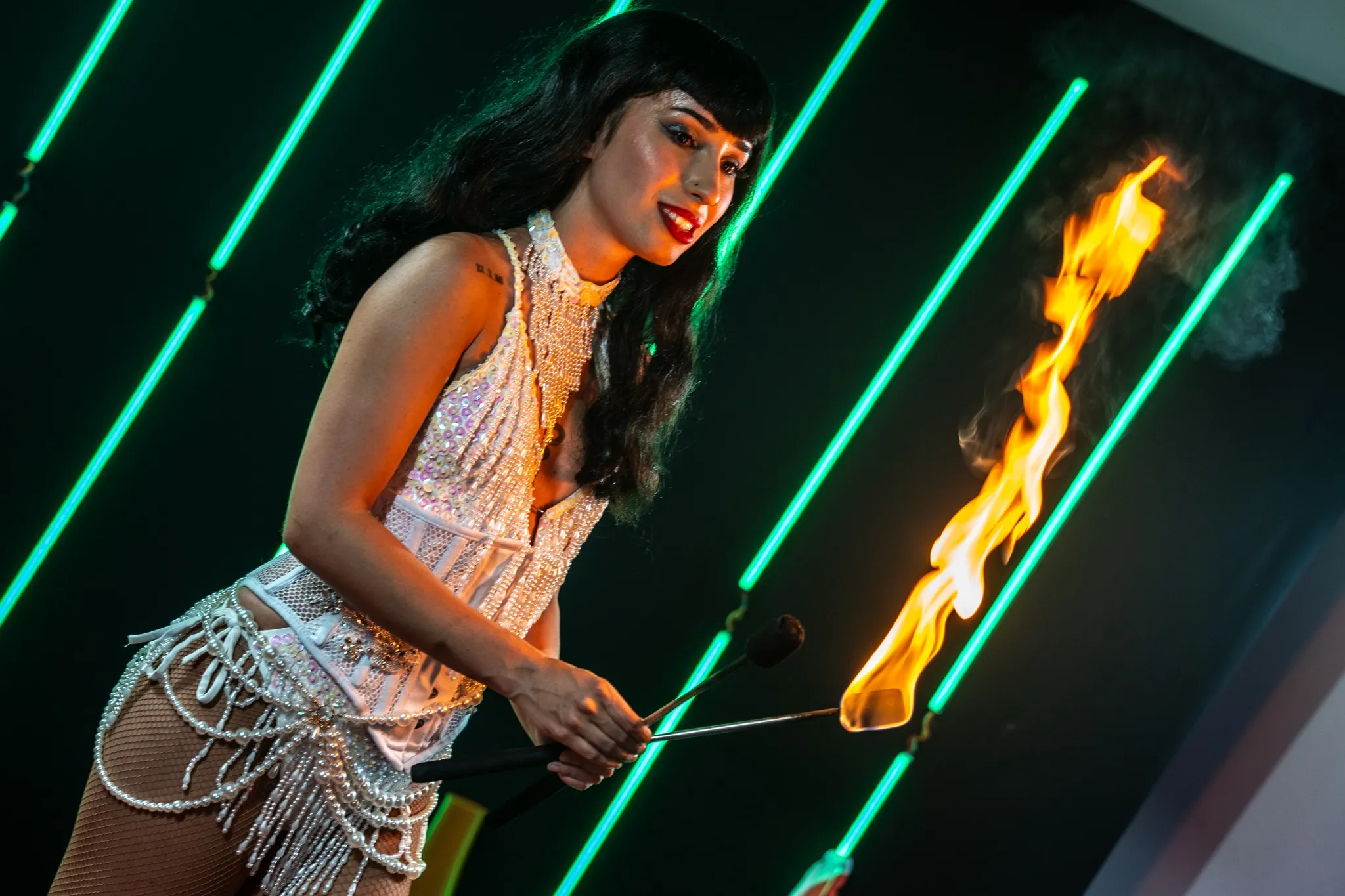 Woman with flames in front of lights